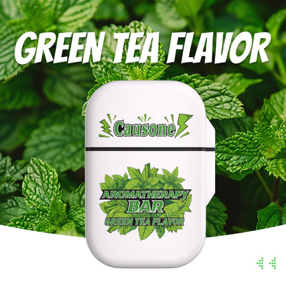 Green tea scented portable aromatherapy nasal inhaler case against fresh green tea leaves backdrop
