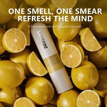 Dual use sniff and roll on essential oil stick laid among lemon slices
